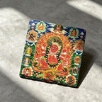 Red Jambhala black slate art tile, angled view showing the printed face and slate thickness.