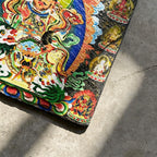 Vaishravana on snow lion black slate art tile, close-up of the printed details, surface texture and slate edge.