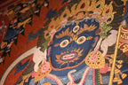 Mahakala face detail with three eyes and a skull crown