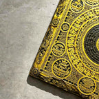 Tibetan Buddhist mandala black slate art tile, close-up of the printed details, surface texture and slate edge.
