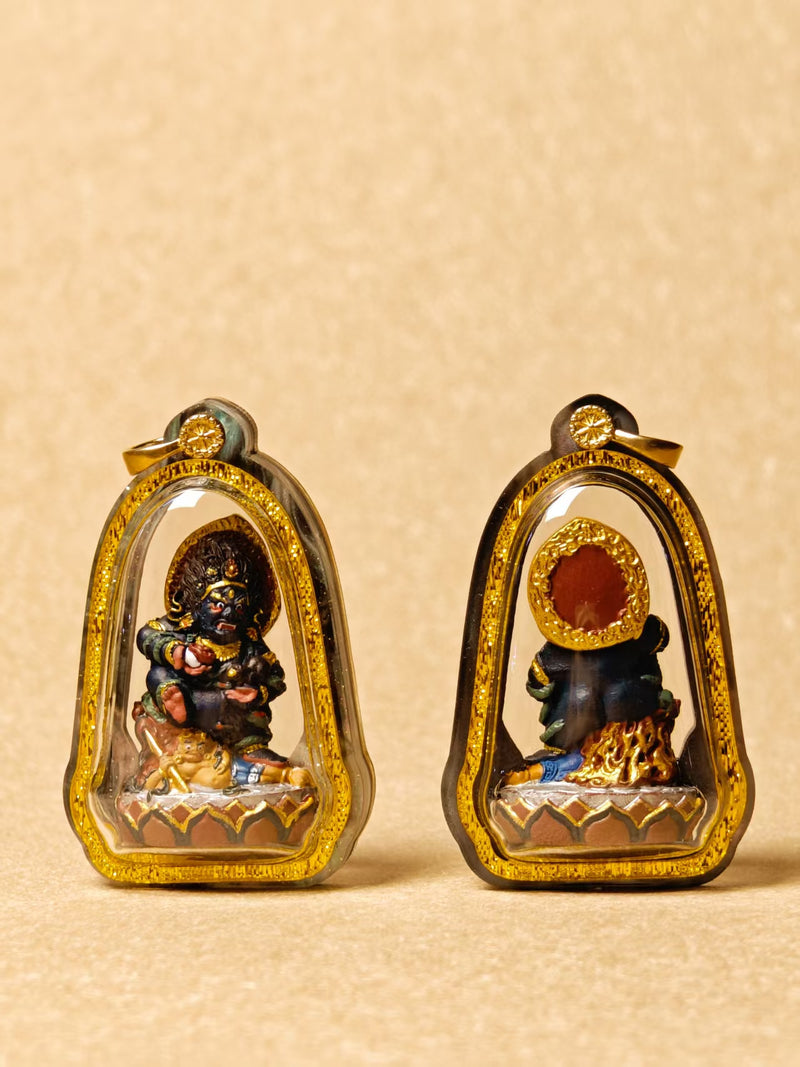 Black Jambhala pendant and its reverse shown side by side