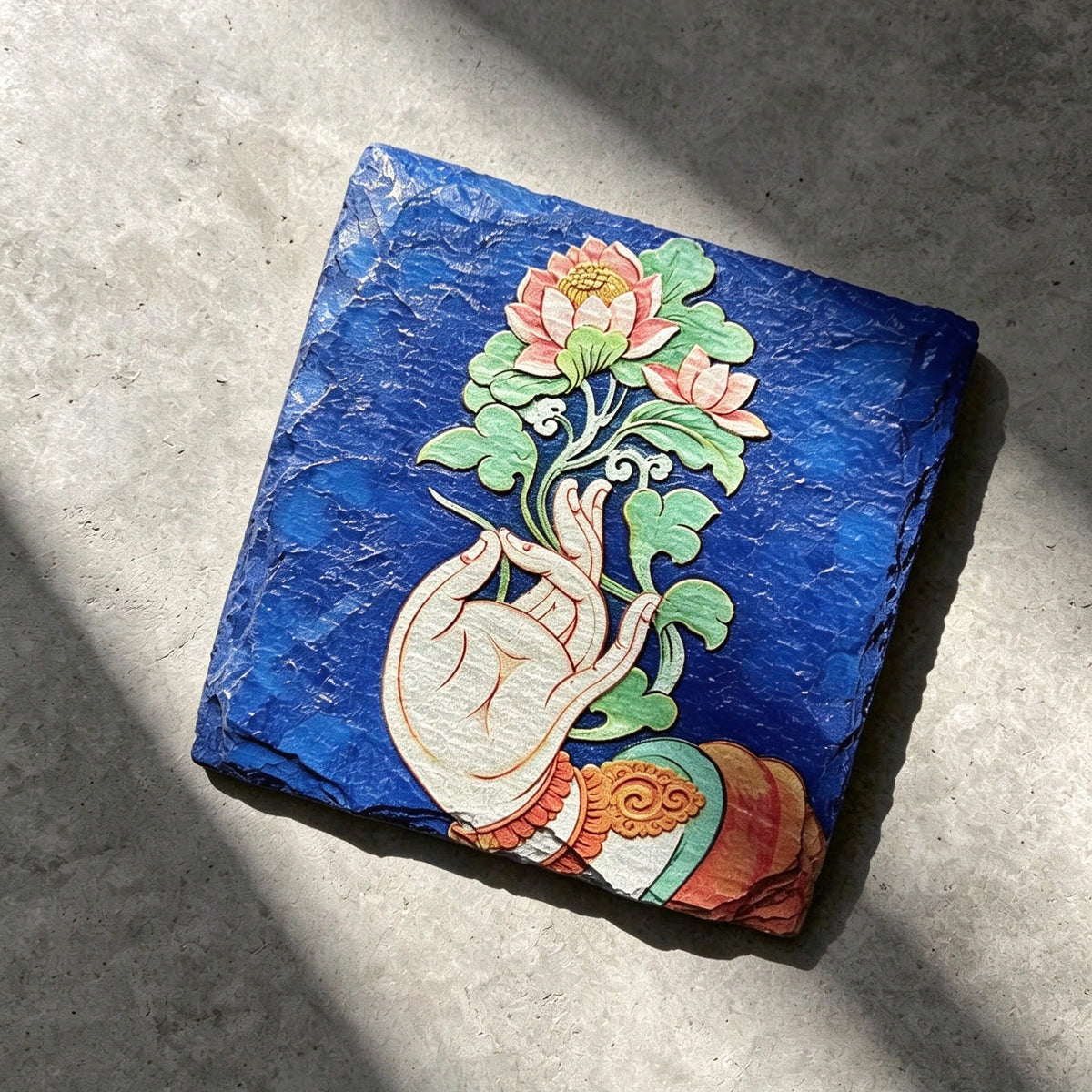 Lotus and hand black slate art tile, angled view showing the printed face and slate thickness.