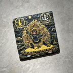 Black Mahakala black slate art tile, angled view showing the printed face and slate thickness.