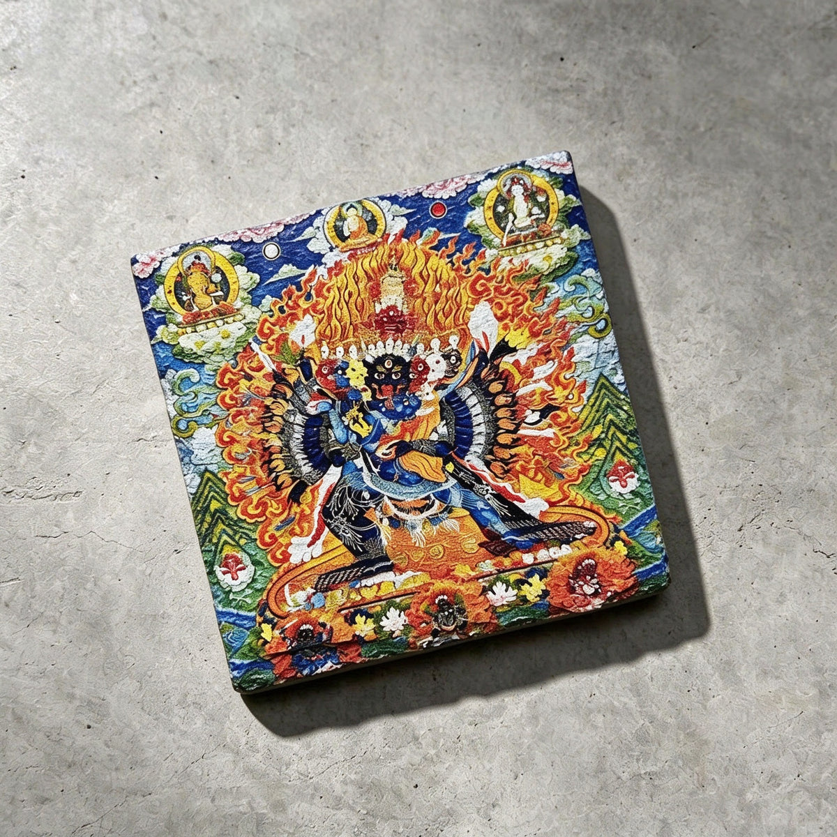 Yamantaka black slate art tile, angled view showing the printed face and slate thickness.
