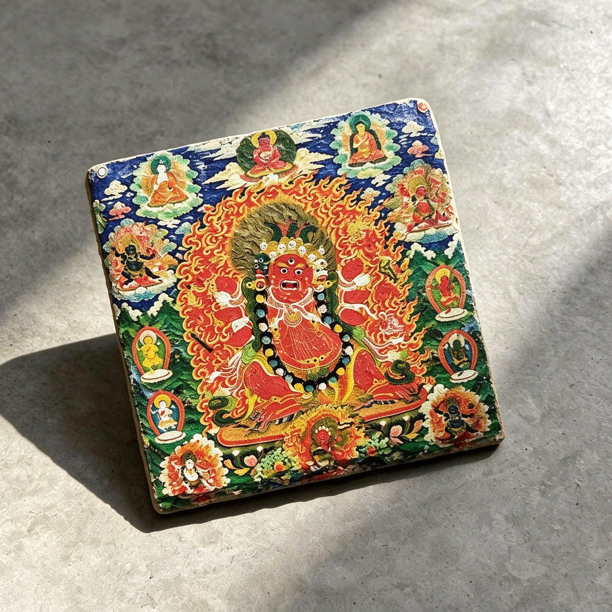 Red Jambhala black slate art tile, angled view showing the printed face and slate thickness.