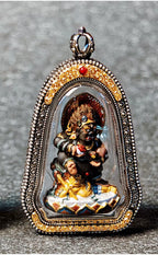 Front view of the Black Jambhala Tsa Tsa pendant in an ornate case
