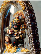 Close-up of the Black Jambhala figure through the clear pendant cover