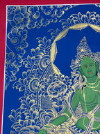 Upper-left flowers and crowned figure — Blue-and-gold Green Tara thangka