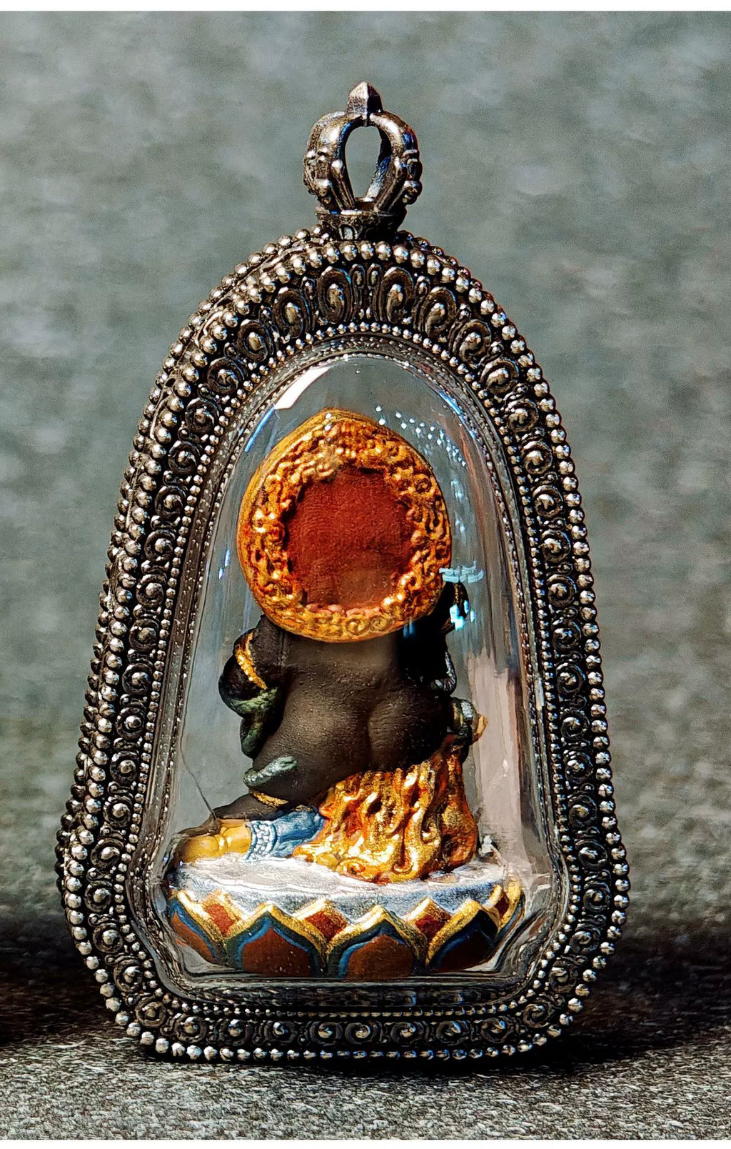 Rear view of the Black Jambhala pendant through its clear cover