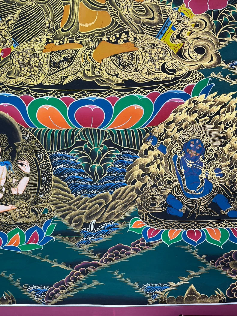 Lower-right blue figure beneath lotus — Manjushri sword-and-lotus thangka