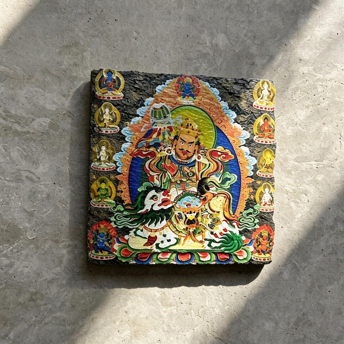 Vaishravana on snow lion black slate art tile, angled view showing the printed face and slate thickness.