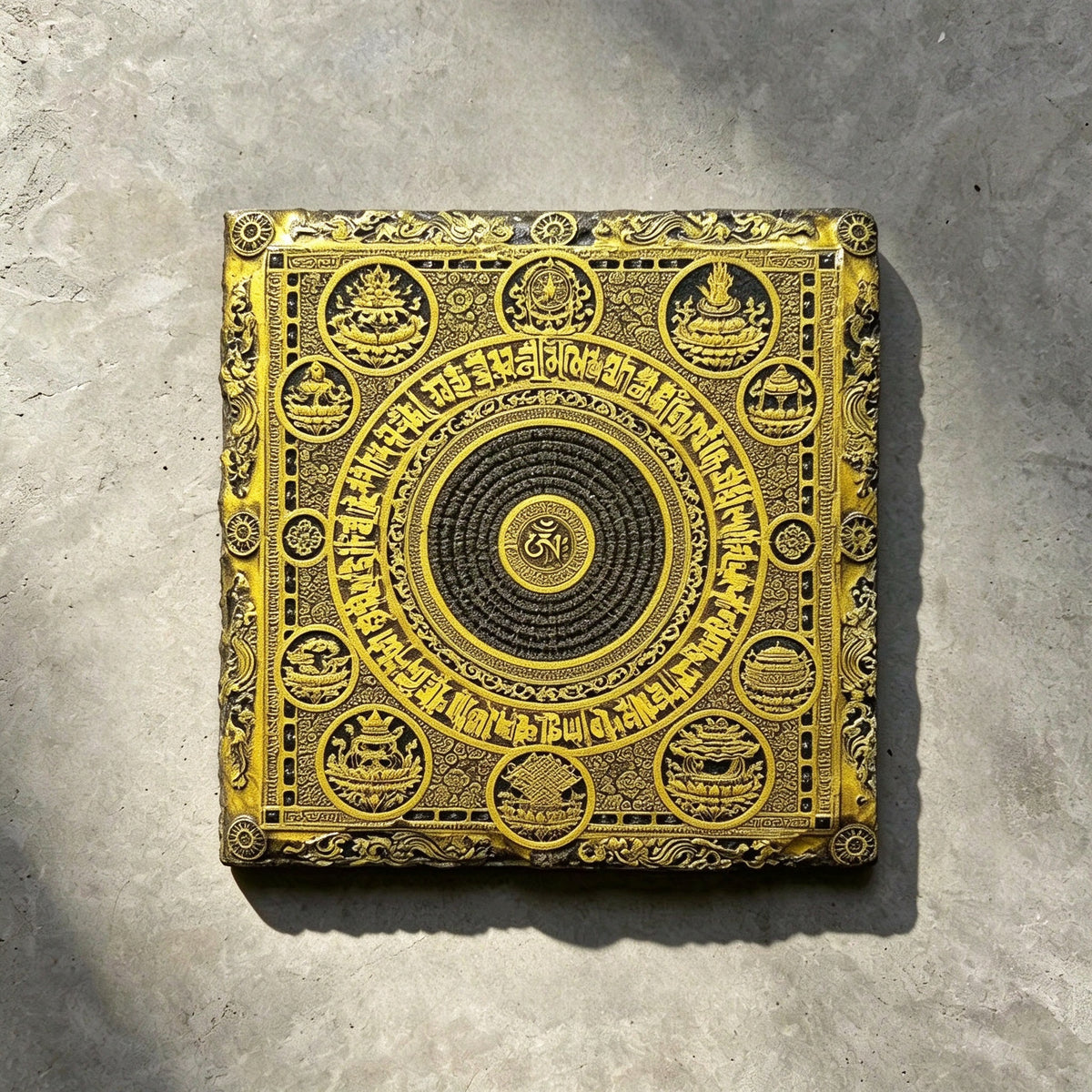 Tibetan Buddhist mandala black slate art tile, front view of the printed artwork and natural slate edges.