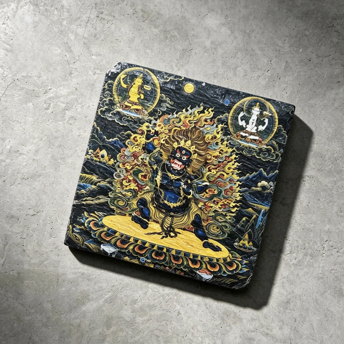 Black Mahakala black slate art tile, angled view showing the printed face and slate thickness.