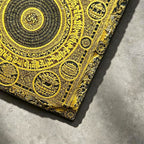 Tibetan Buddhist mandala black slate art tile, close-up of the printed details, surface texture and slate edge.