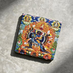 Yamantaka black slate art tile, angled view showing the printed face and slate thickness.