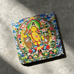 Yellow Manjushri black slate art tile, angled view showing the printed face and slate thickness.