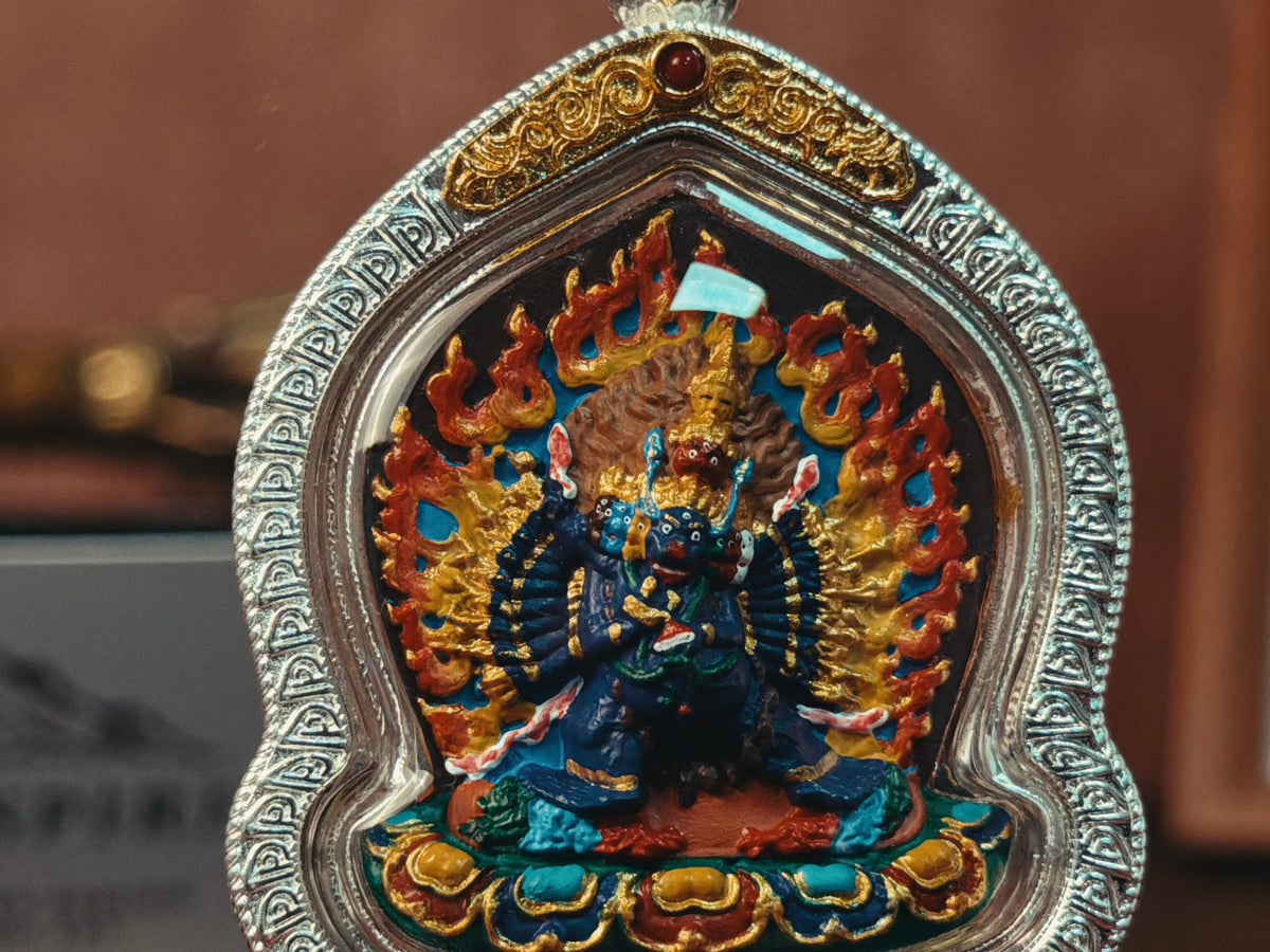 Front close-up of Yamantaka relief and engraved silver-tone case