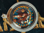 Front detail of Ksitigarbha relief in a round engraved silver-tone gau case