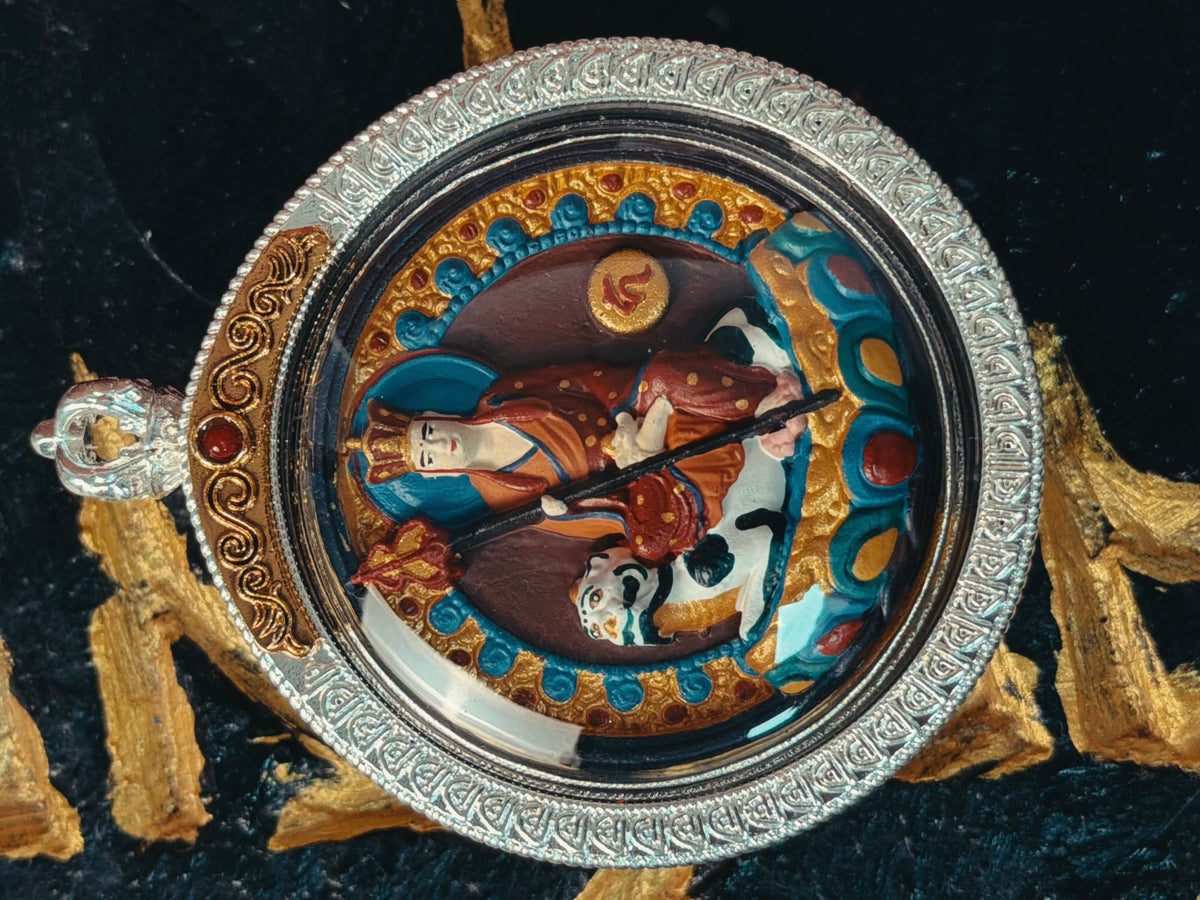 Front detail of Ksitigarbha relief in a round engraved silver-tone gau case