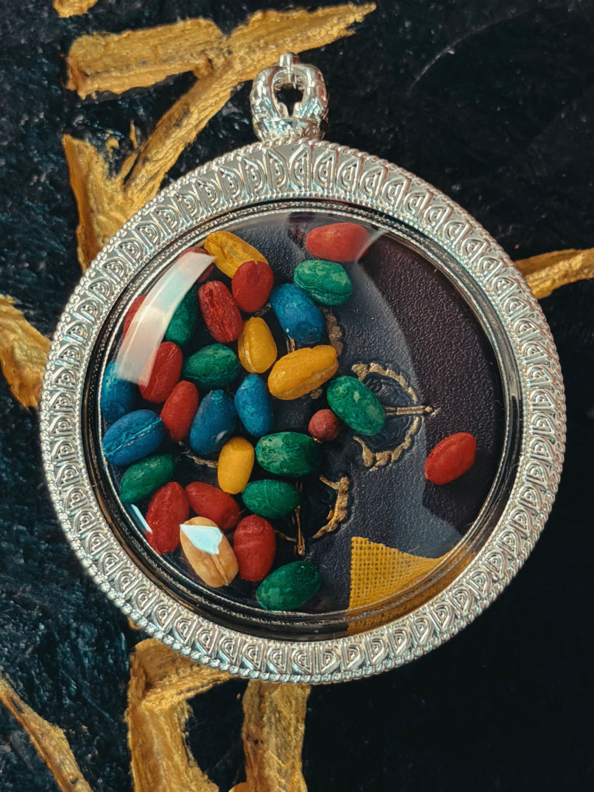 Close-up of the transparent reverse and colorful contents of Ksitigarbha pendant